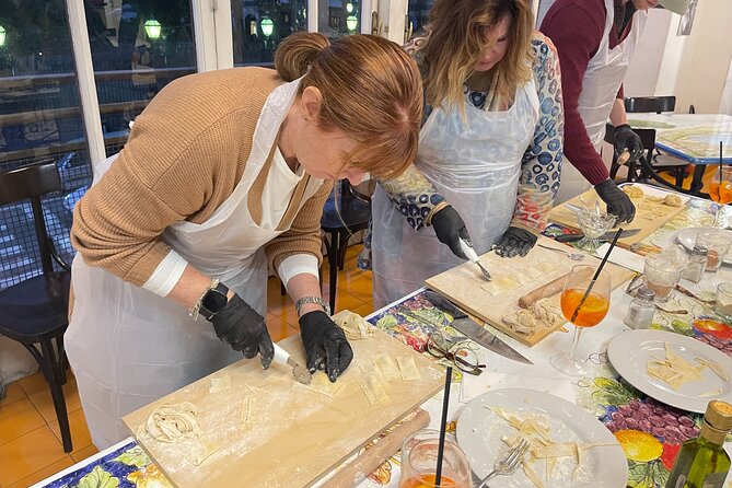 Hands-On Pasta Making and Traditional Tiramisu Workshop - Egg pasta with hands and a rolling pin