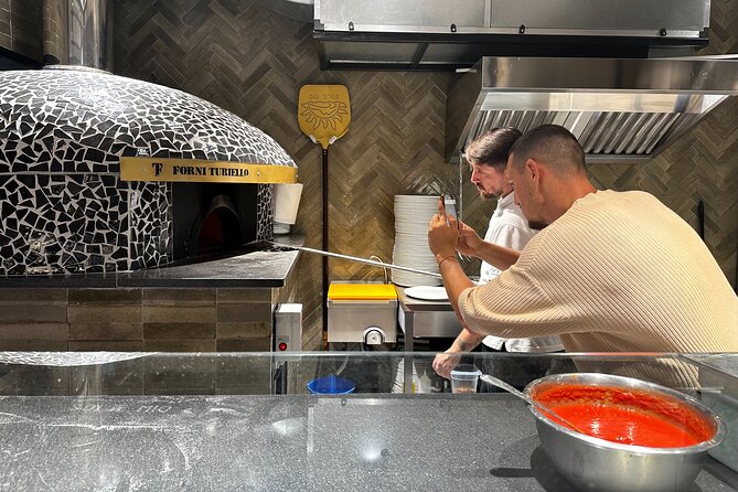 Naples Pizza Class: Learn, Bake & Eat the Authentic Pizza Taste - Getting the pizza into the oven