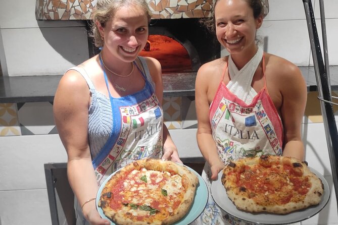 Semi-Private Pizza Making Experience in Naples with Drink - Stretching, topping, and sliding the pizza into the oven